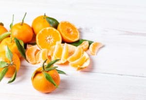orange fruit on white surface